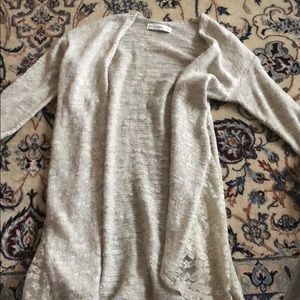 Cute cardigan with lace cutouts on the sides